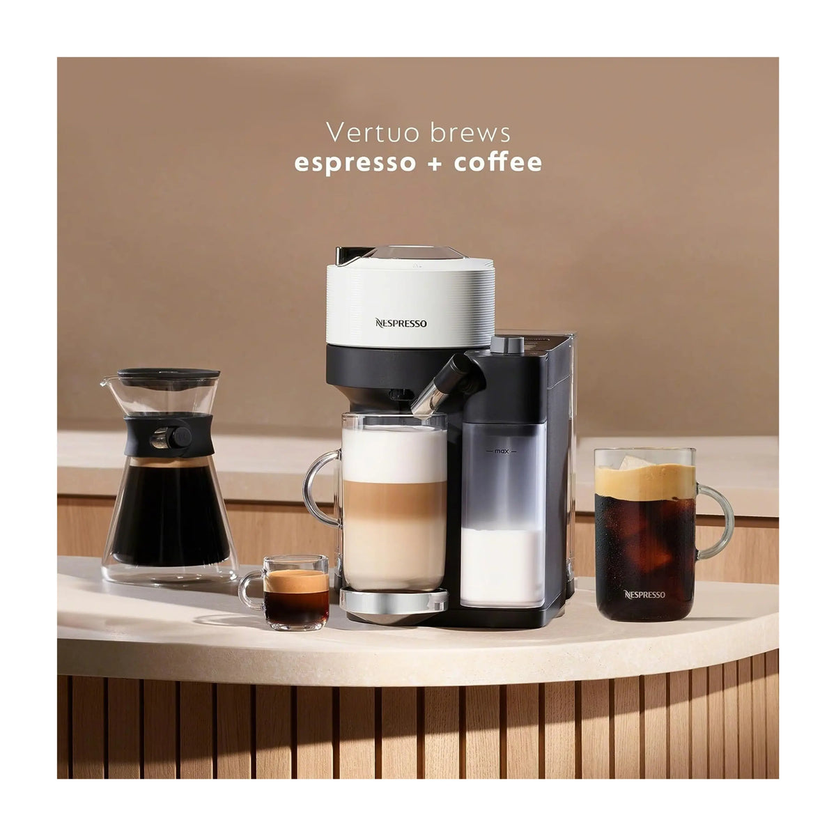 White and black Nespresso Vertuo coffee machine with cups and glass container