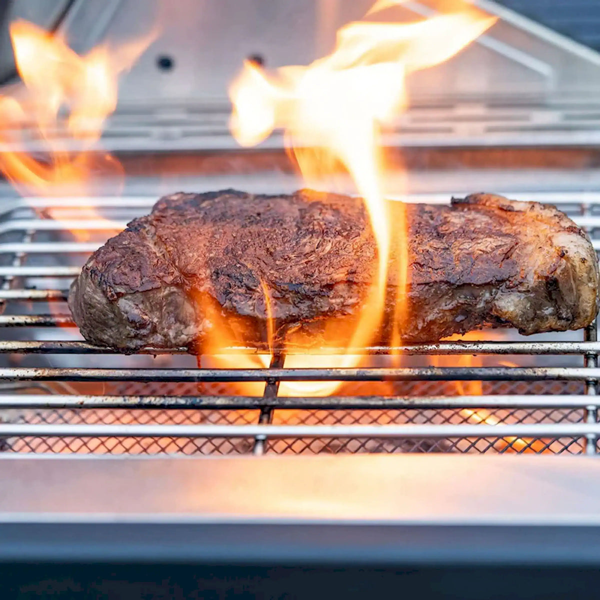 Hot infrared grill grates with searing steaks and open flame