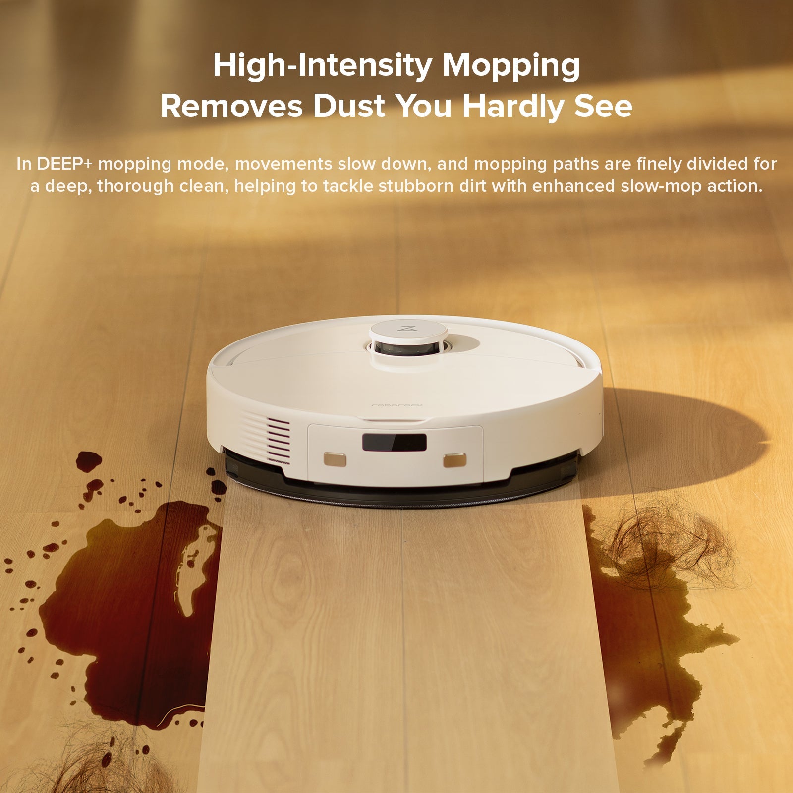 White robot vacuum and mop on floor with visible dirt marks