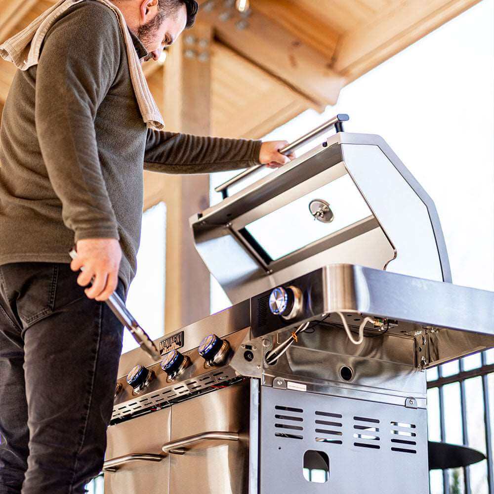 Man connecting a hose to stainless steel gas grill control panel