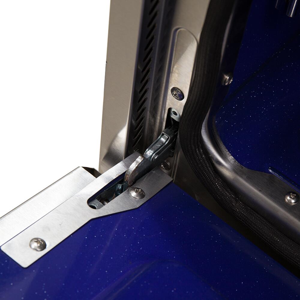 Oven door seal and latch hardware on a blue interior panel