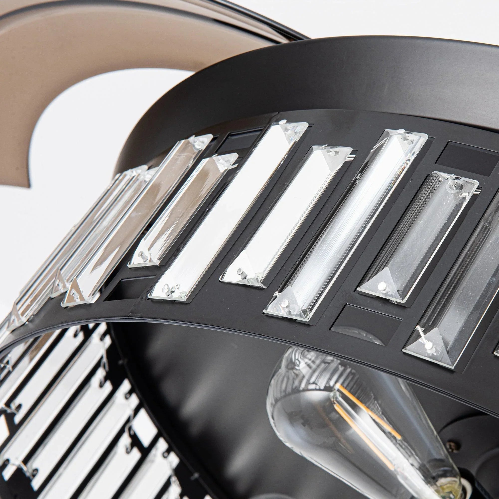 Close-up of black fan light ring with rectangular metal panels and clear bulbs