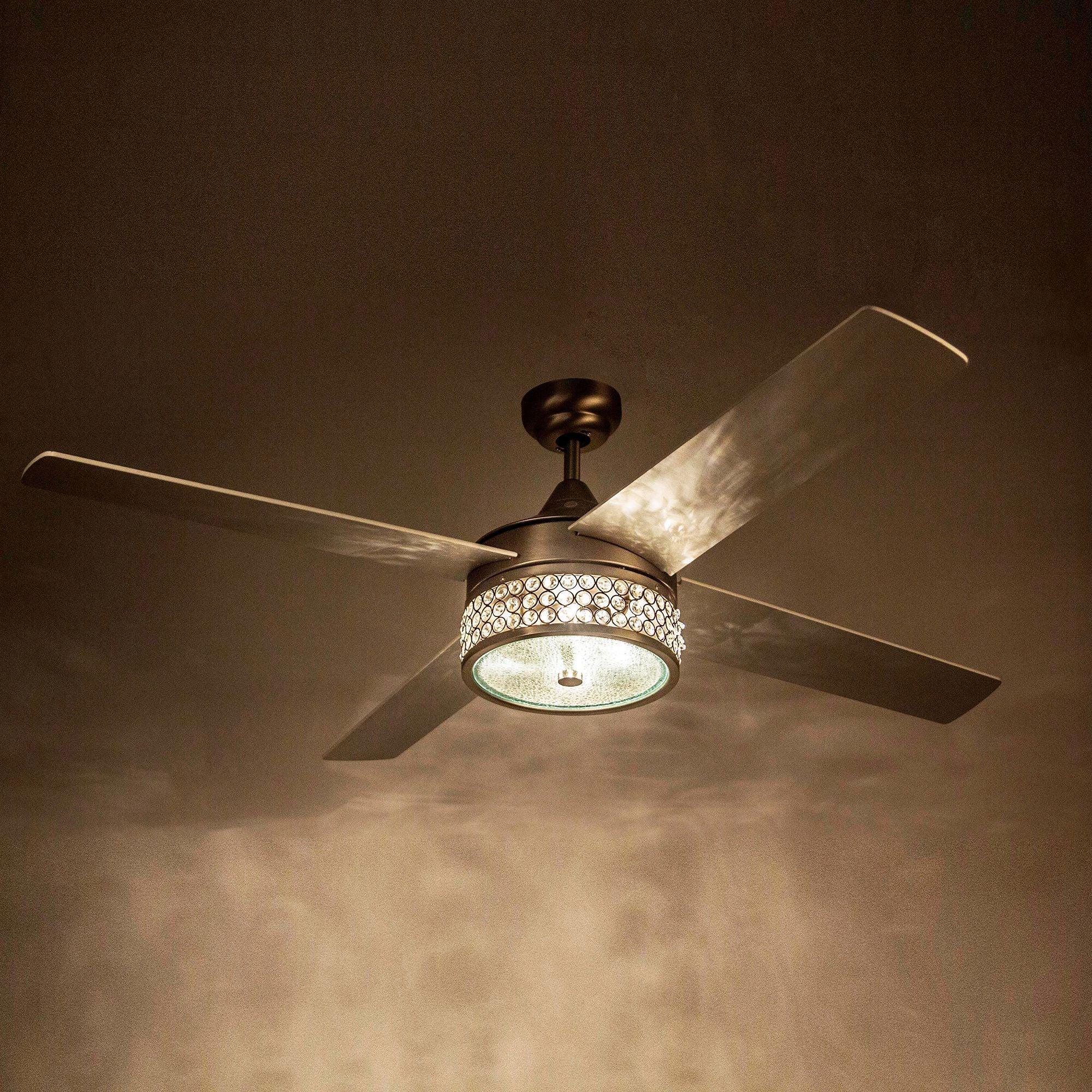 Black ceiling fan with five reversible blades and glowing LED light under ceiling