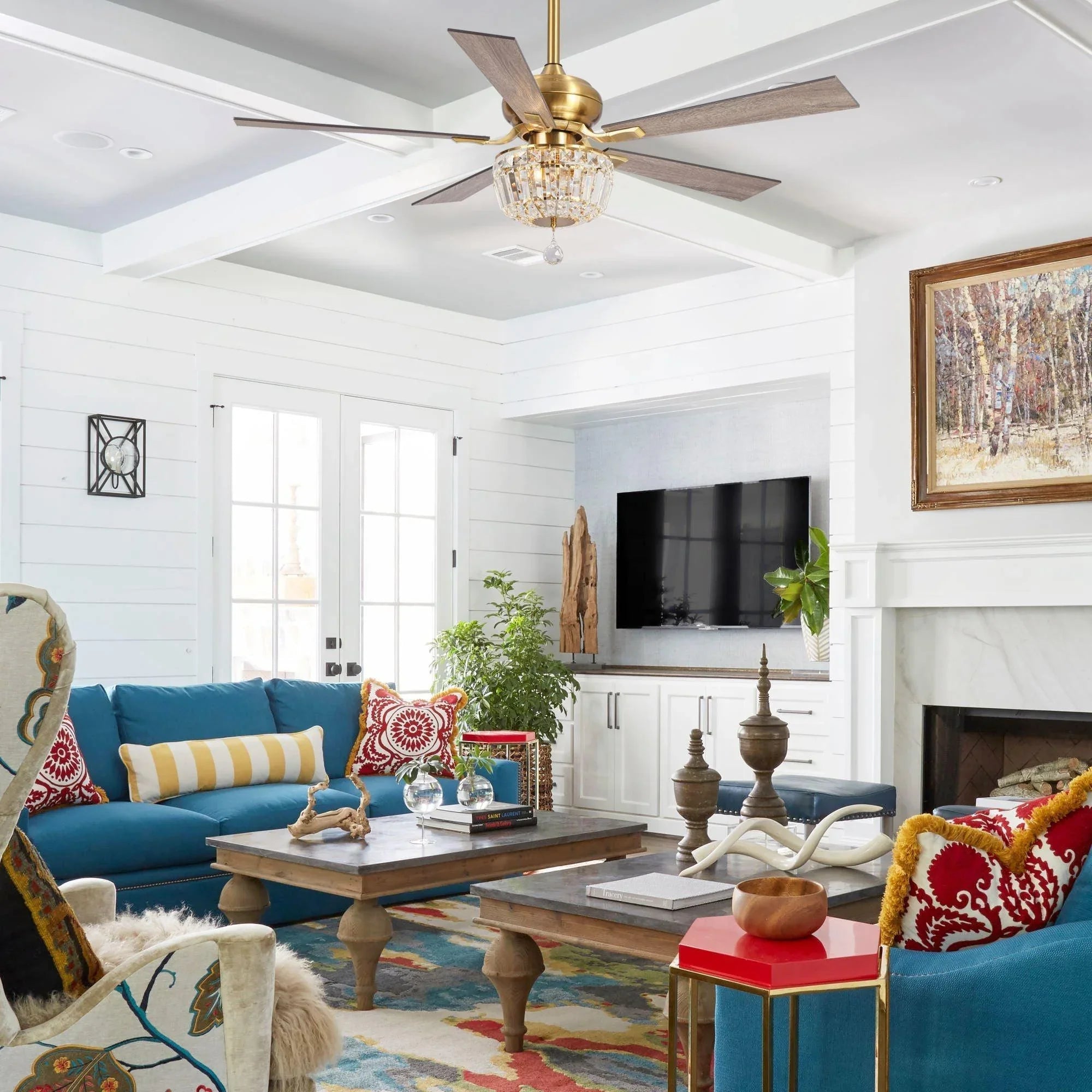Gold ceiling fan with crystal light and modern five-blade design in living room