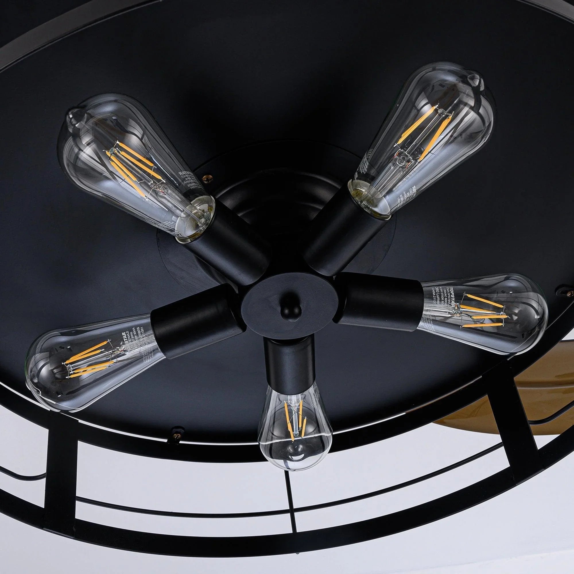 Black industrial ceiling fan with four clear glass light bulbs and wide blade arms