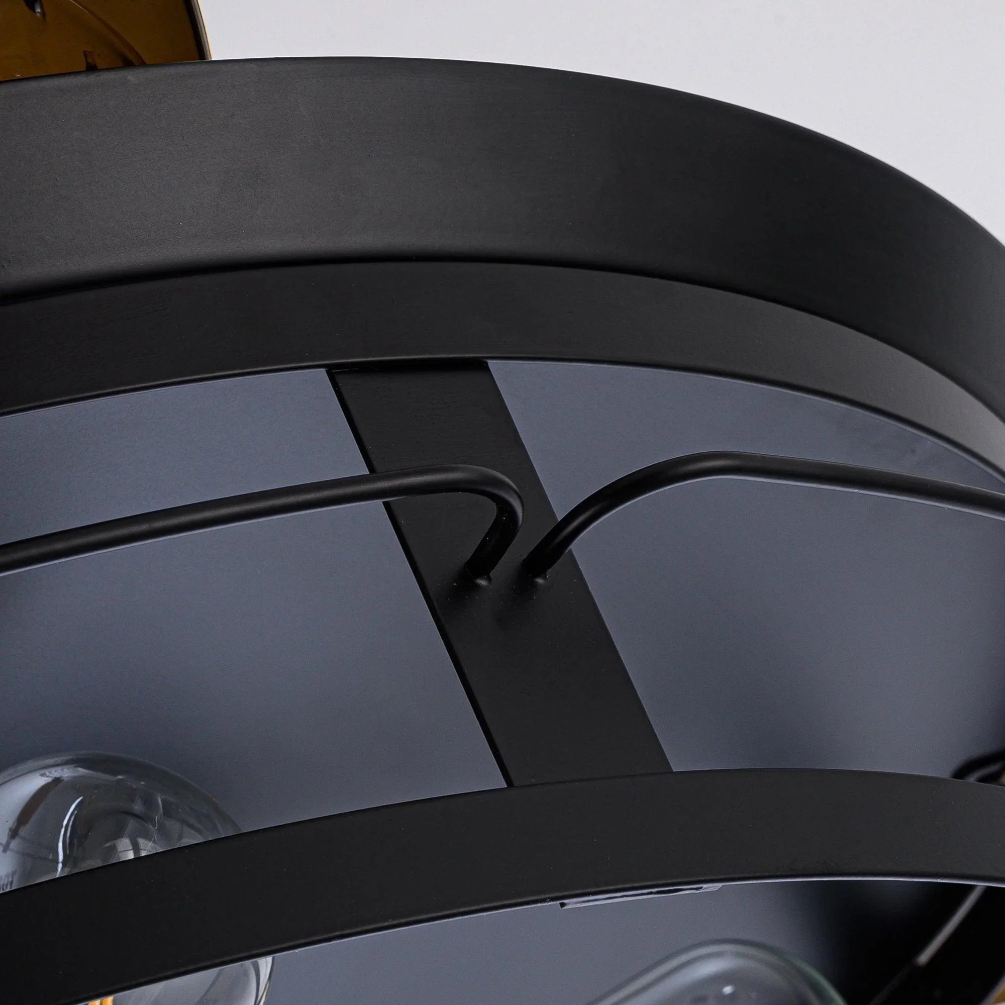 Black ceiling fan blade and curved arm detail with glossy finish