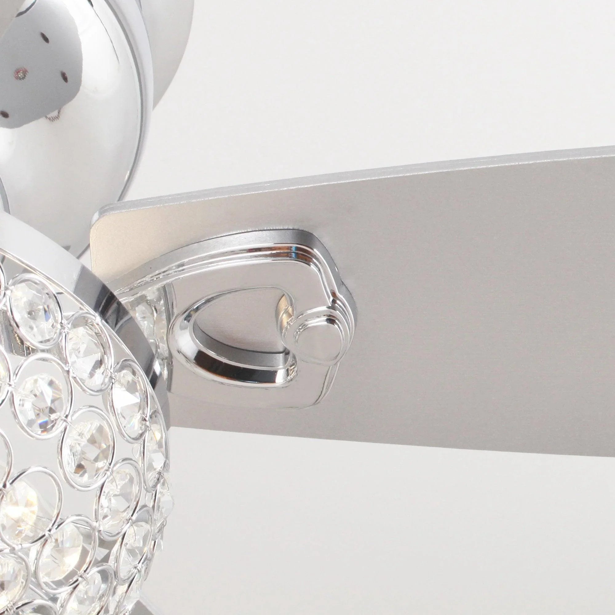 Chrome ceiling fan mounting bracket with smooth flush canopy and crystal light