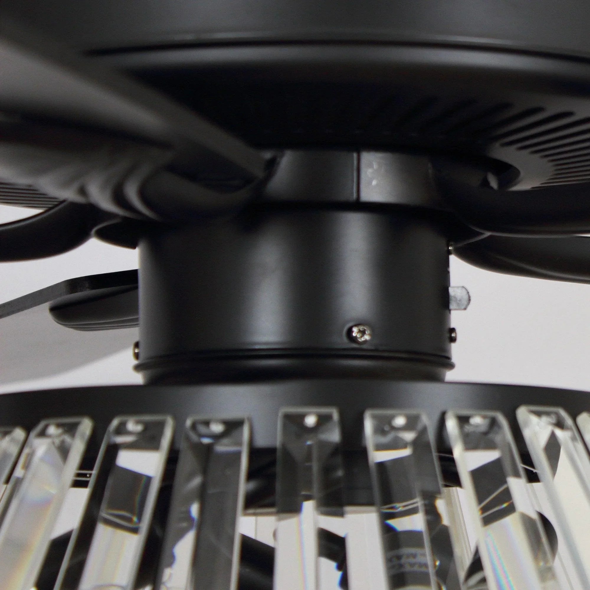 Black ceiling fan motor housing with crystal light components below