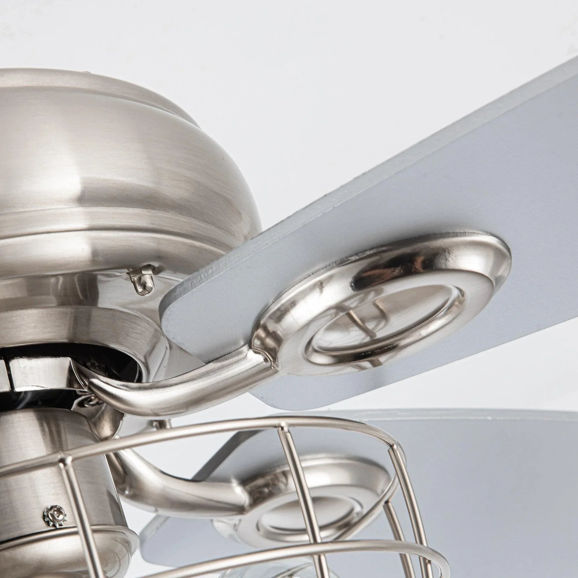 Brushed nickel ceiling fan blade bracket and caged light housing underside
