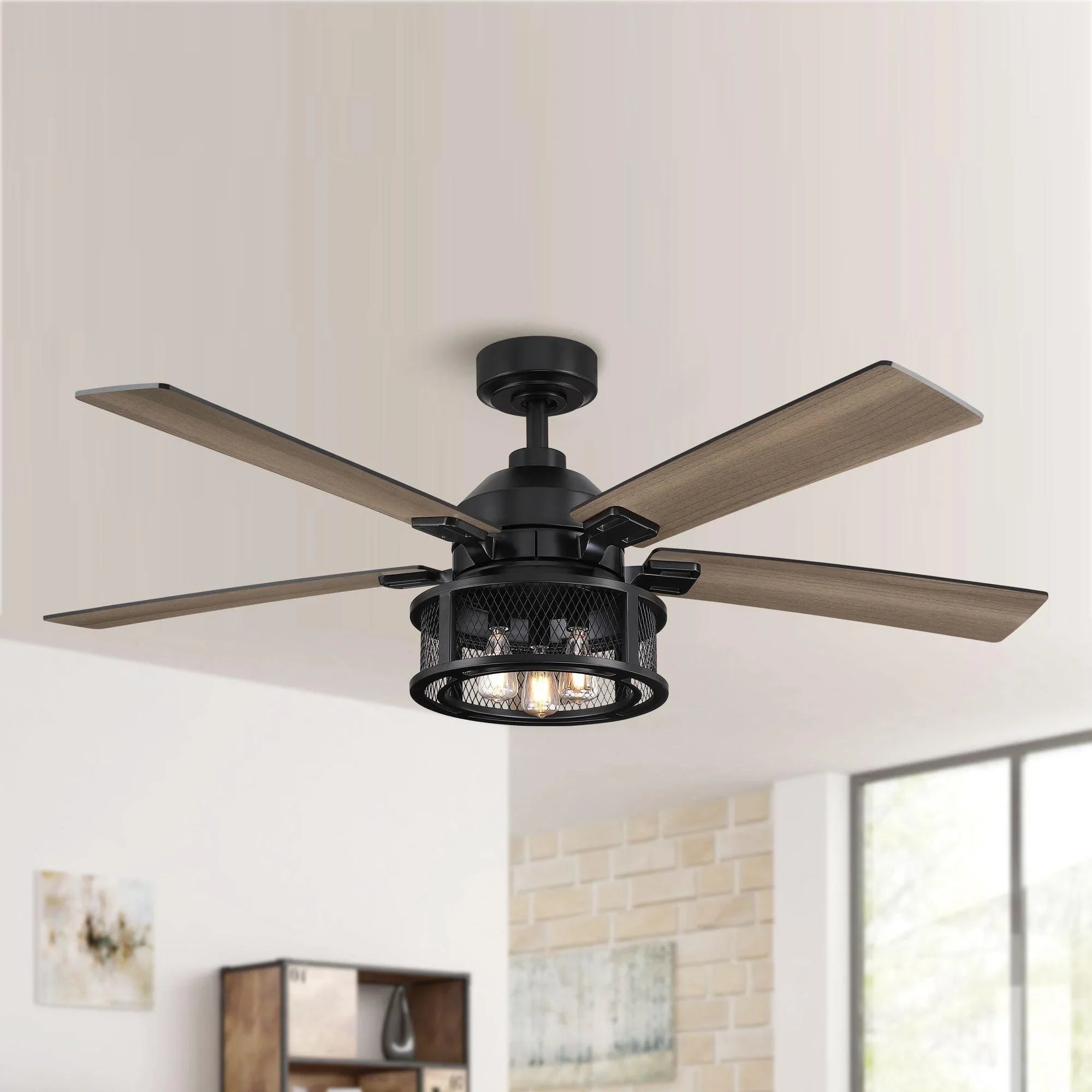Black ceiling fan with five wood blades and round light kit on a mounted ceiling