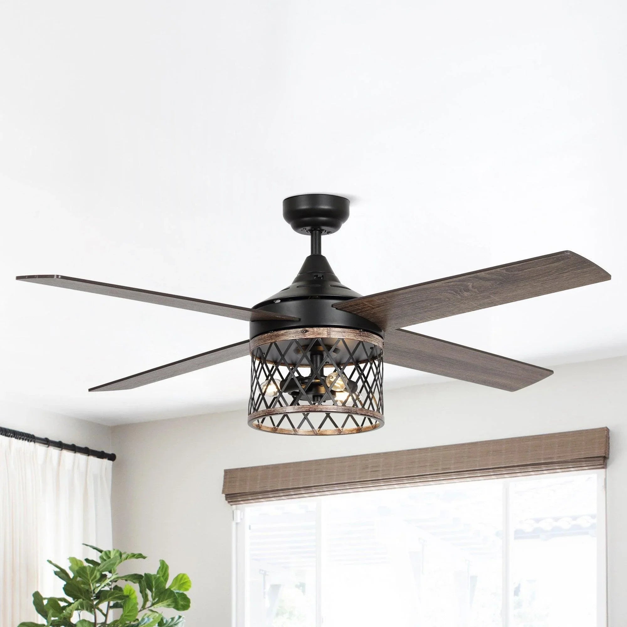 Black ceiling fan with caged light and four wood-toned blades overhead.
