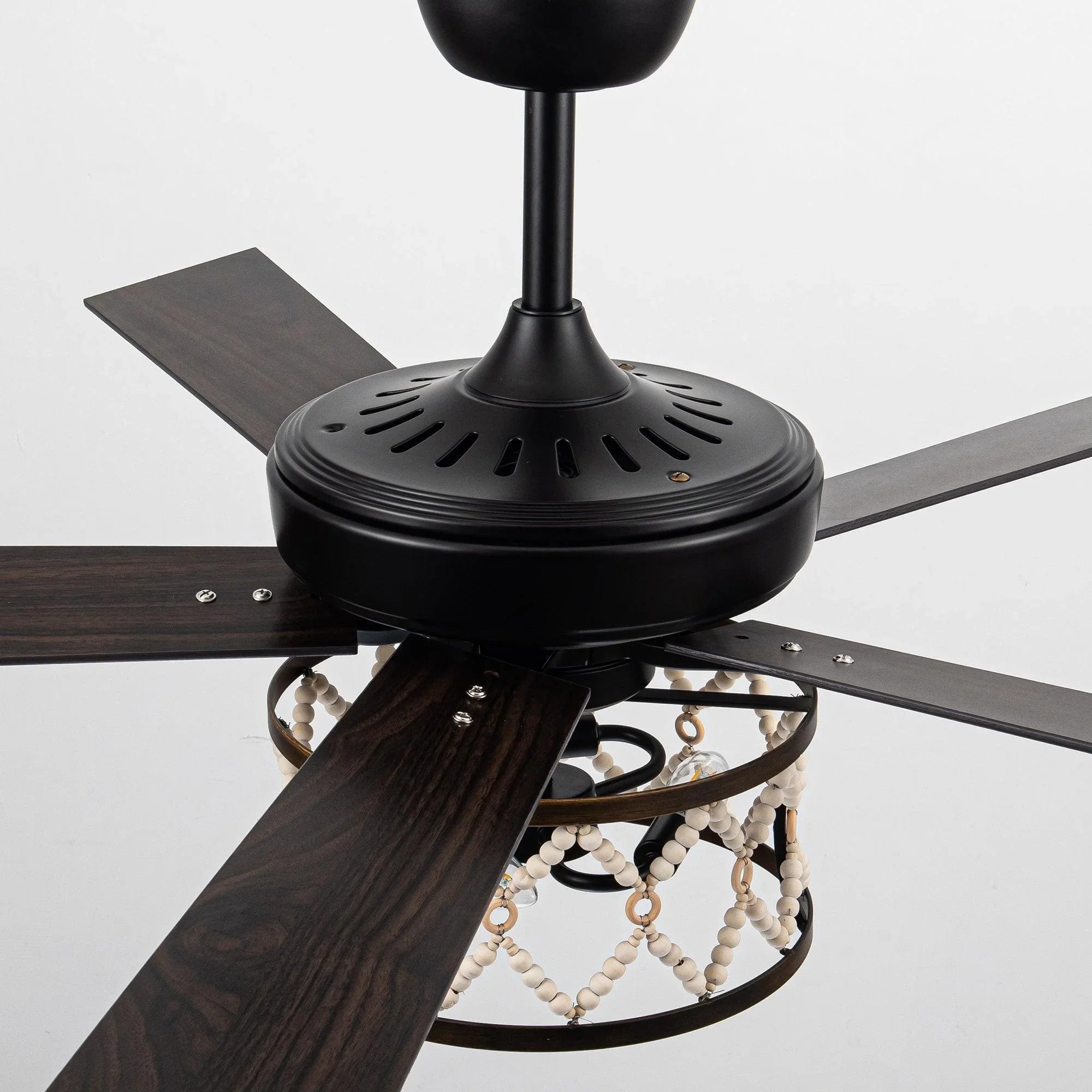 Ceiling fan with black canopy, dark wood blades, and hanging bead light detail