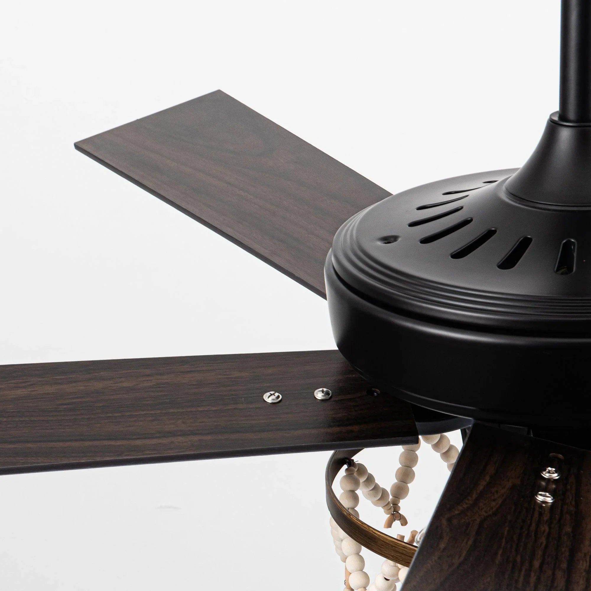 Black ceiling fan motor with dark wood blades and light fixture with bead strands