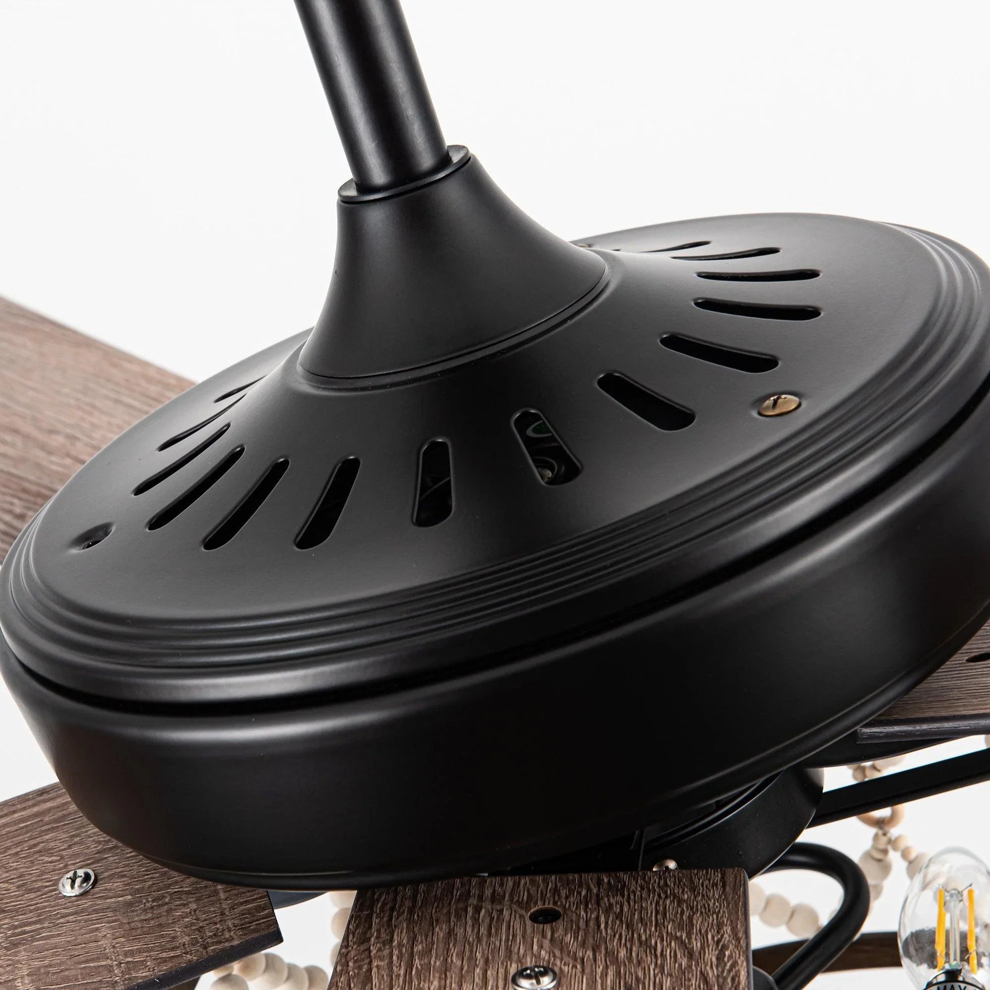 Black ceiling fan motor housing with vented top and mounting bracket.