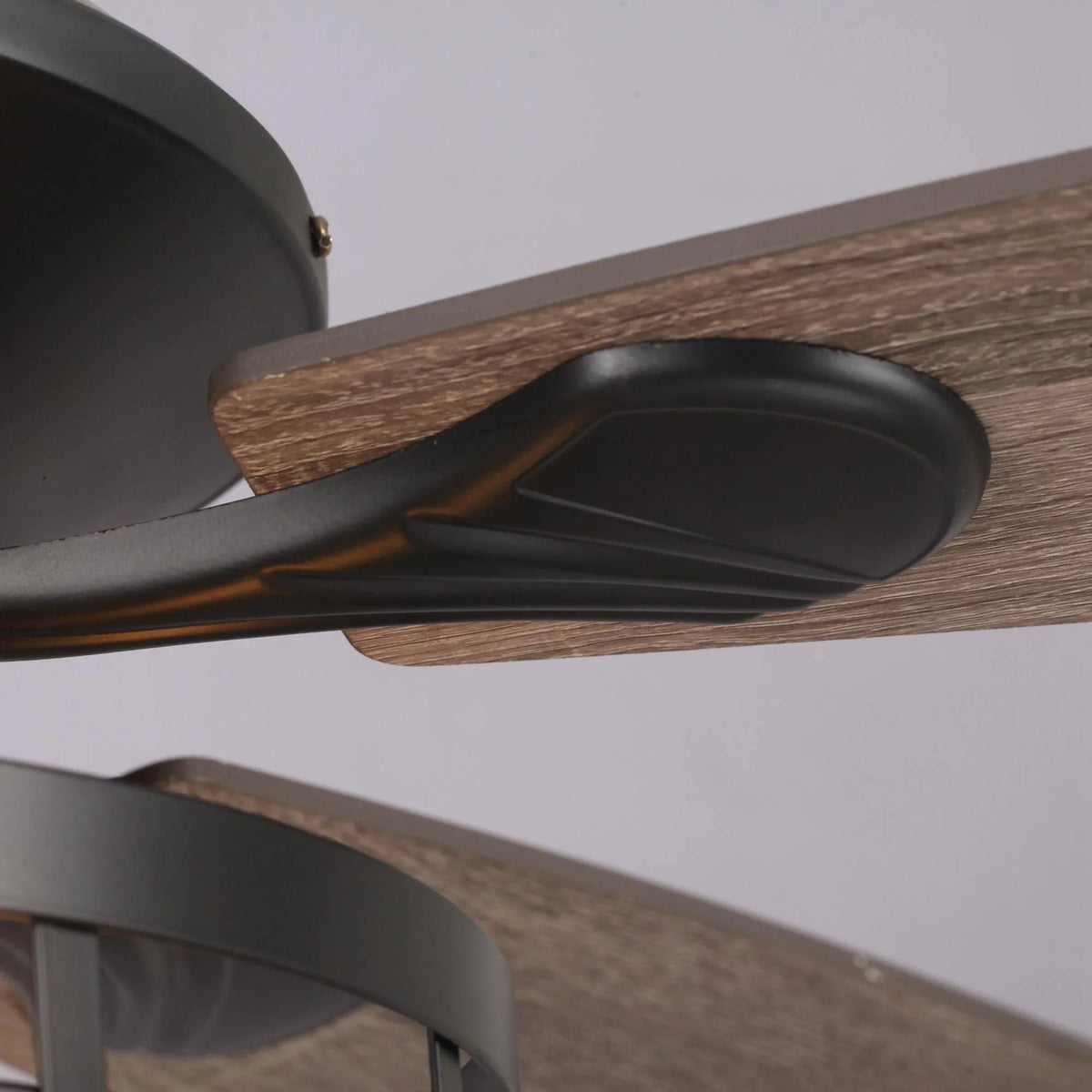 Black ceiling fan blade and housing with wood-toned blade surface
