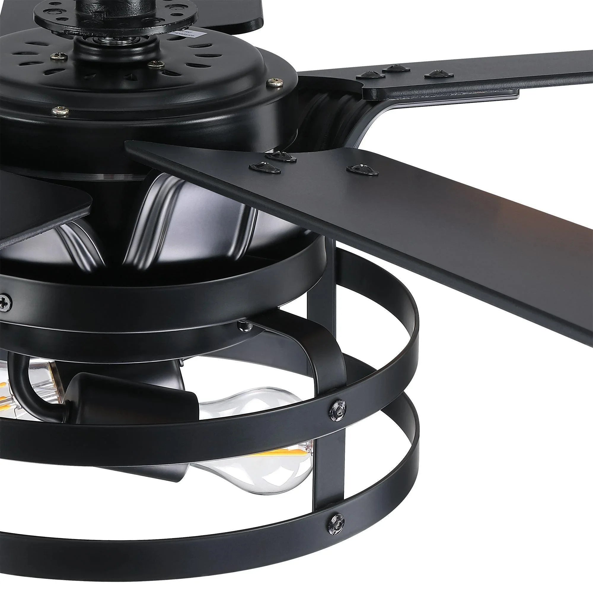 Black ceiling fan motor housing with metal arms beneath caged light
