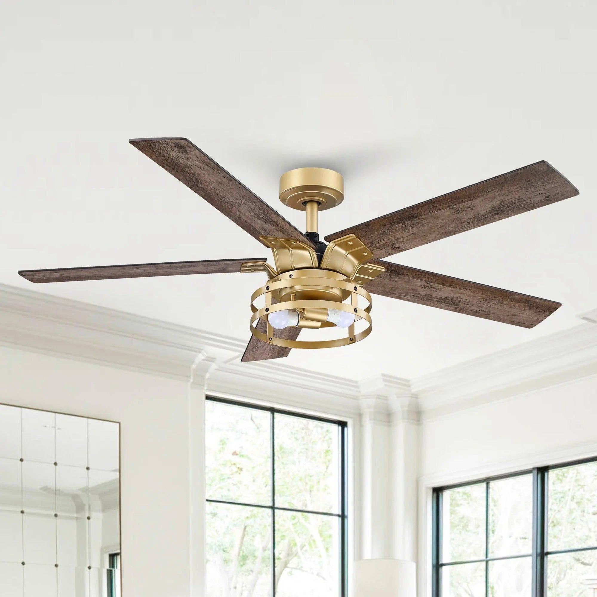 Industrial ceiling fan with light kit and four wood blades, downrod mount, golden finish.