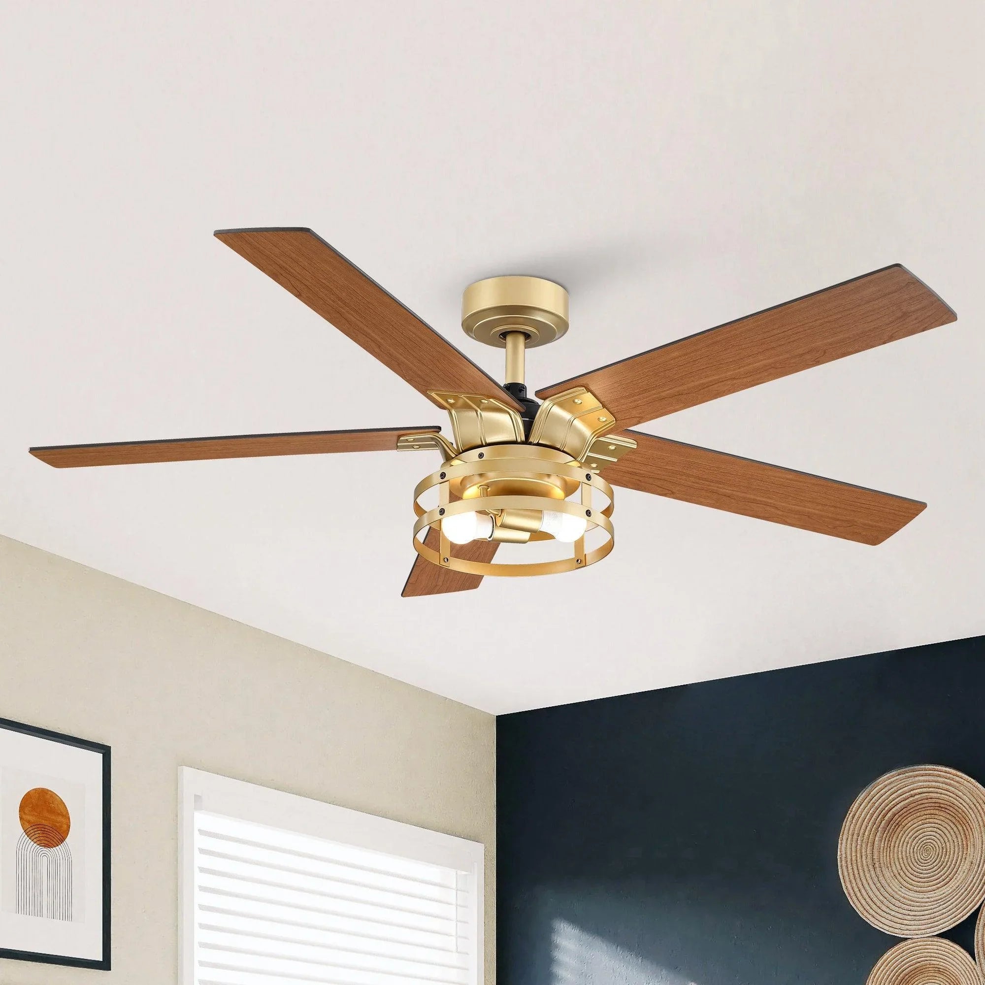 Industrial ceiling fan with light kit and four wood blades on a downrod, golden finish.