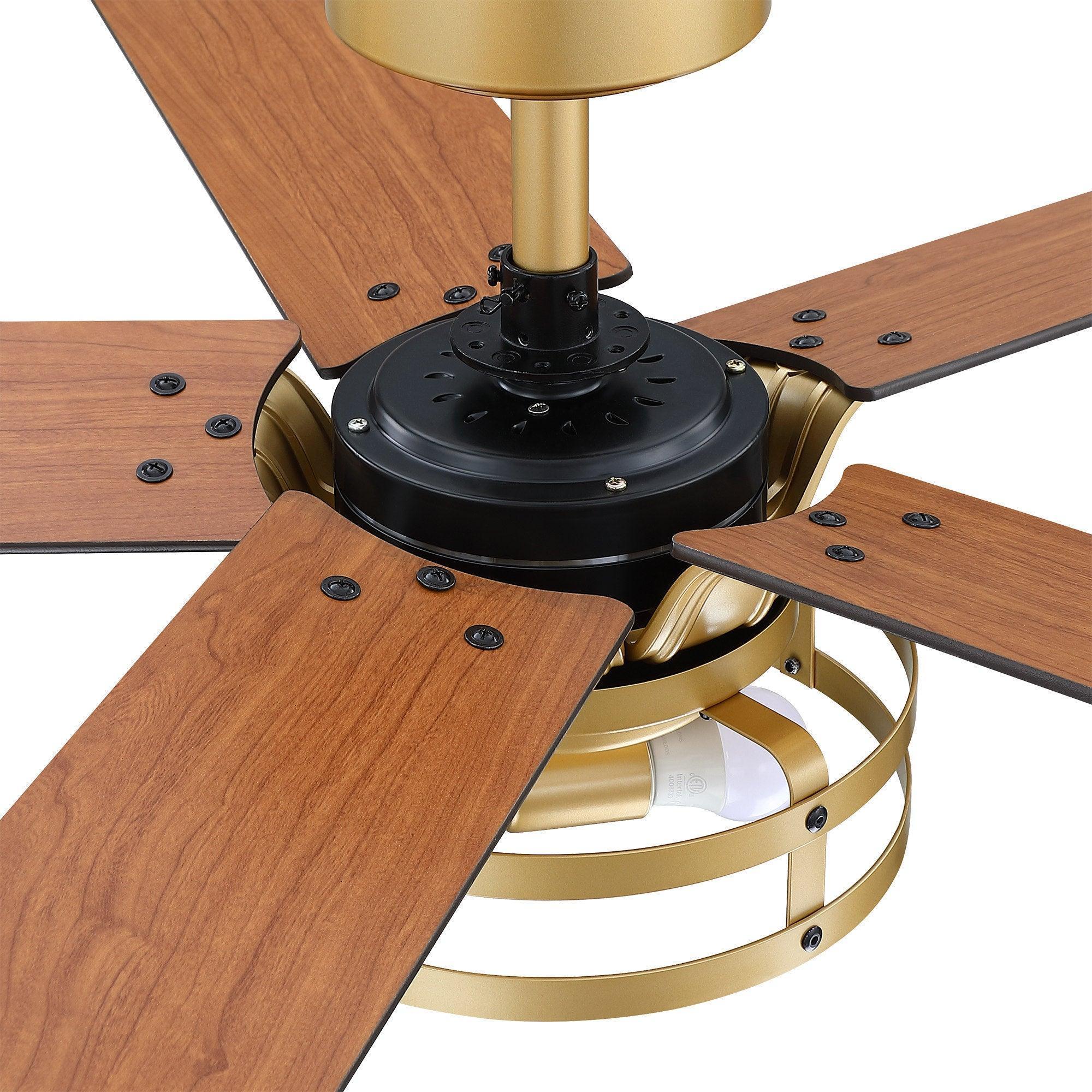 Close-up ceiling fan motor housing with four wood blades and light ring, golden and black.
