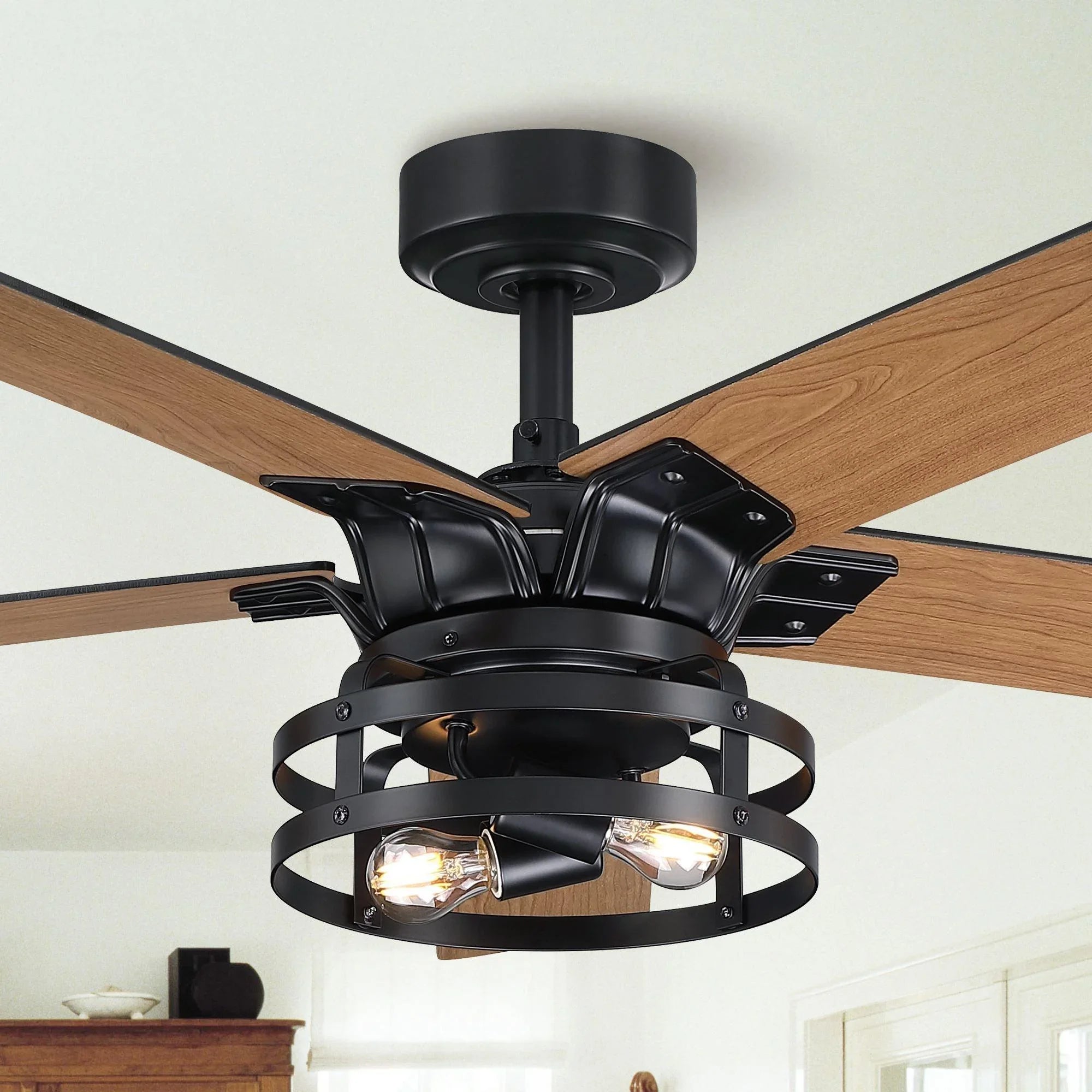 Black ceiling fan with wood blades and caged light, downrod mount view