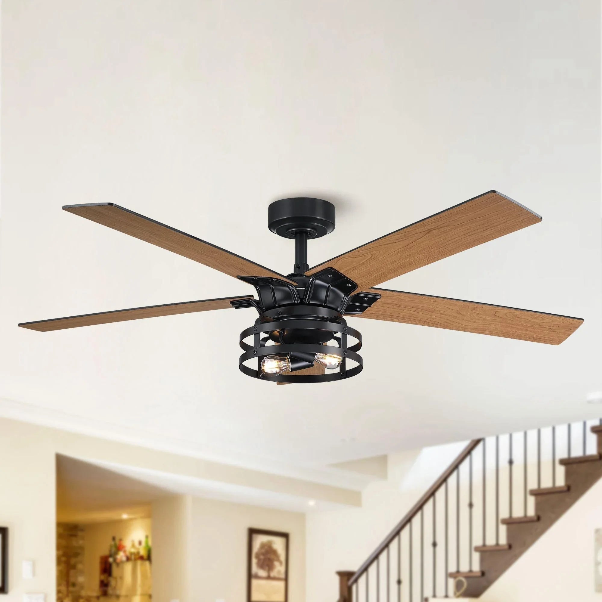 Black ceiling fan with wood blades and caged light fixture on ceiling