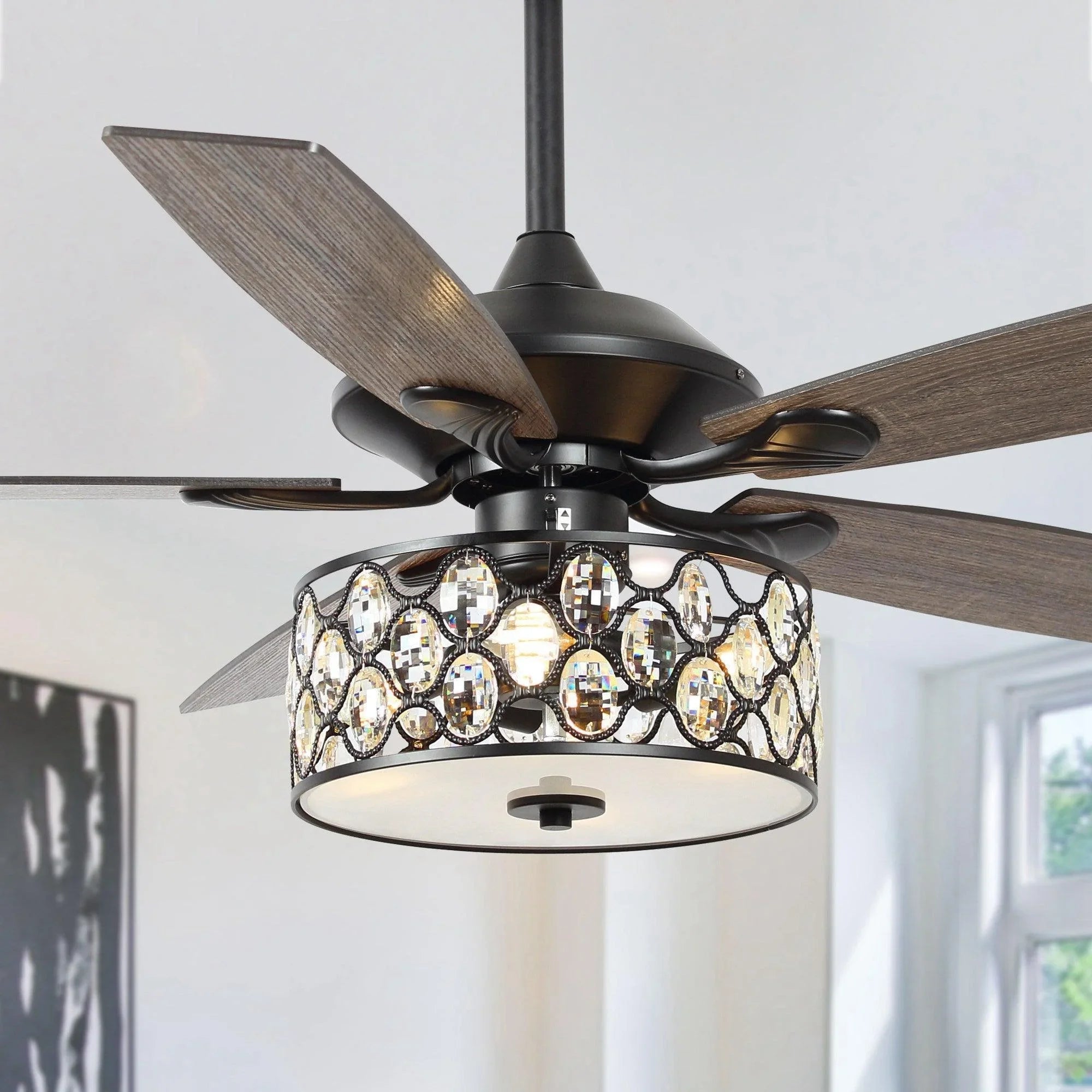 Close-up ceiling fan with dark blades and glowing crystal glass light fixture
