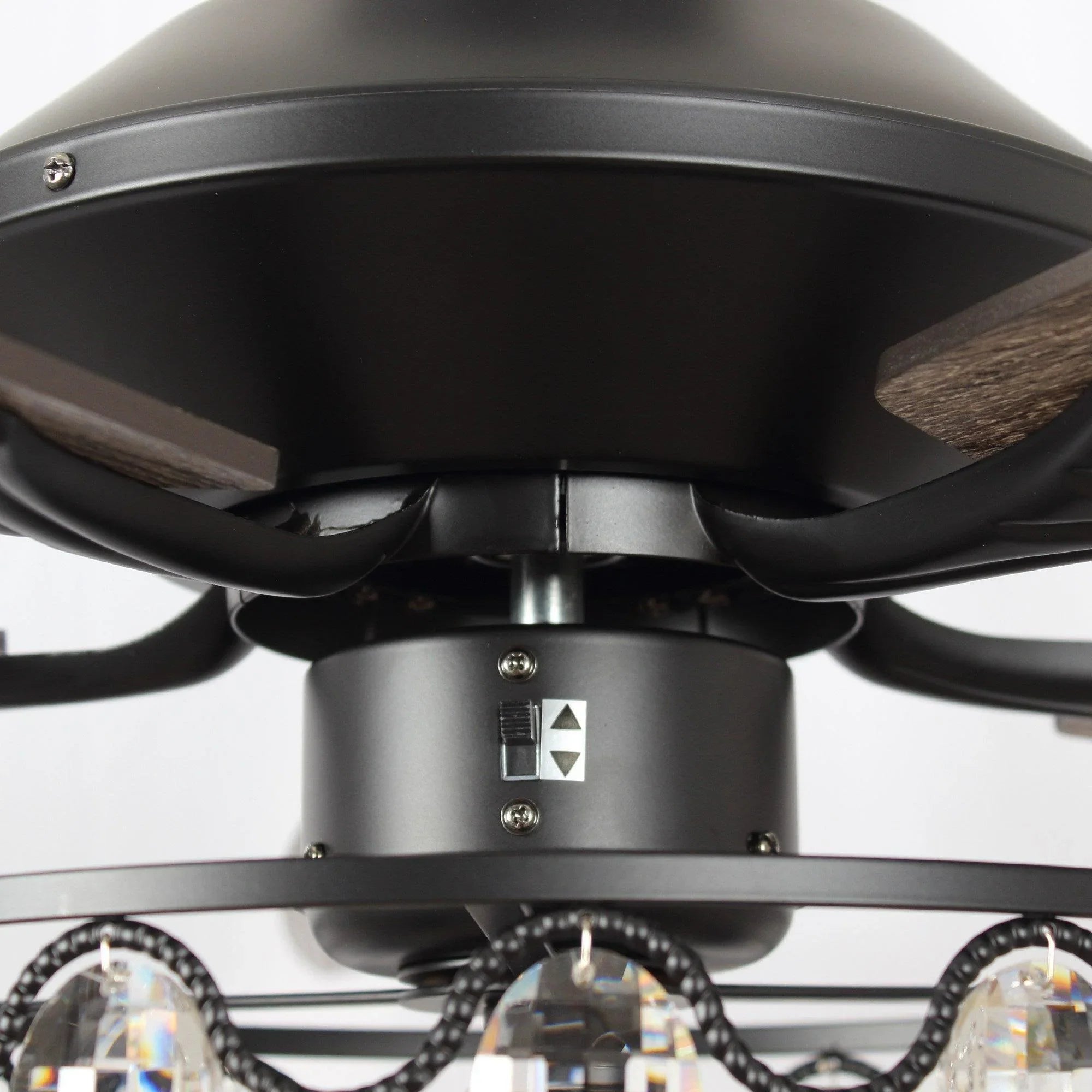 Black ceiling fan canopy and downrod connection with crystal light band below