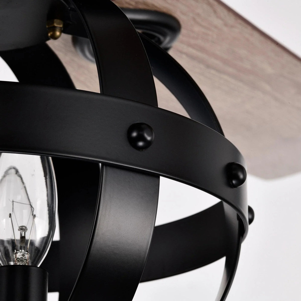 Black ceiling fan blade ring with metal bolts and clear lamp inside lantern