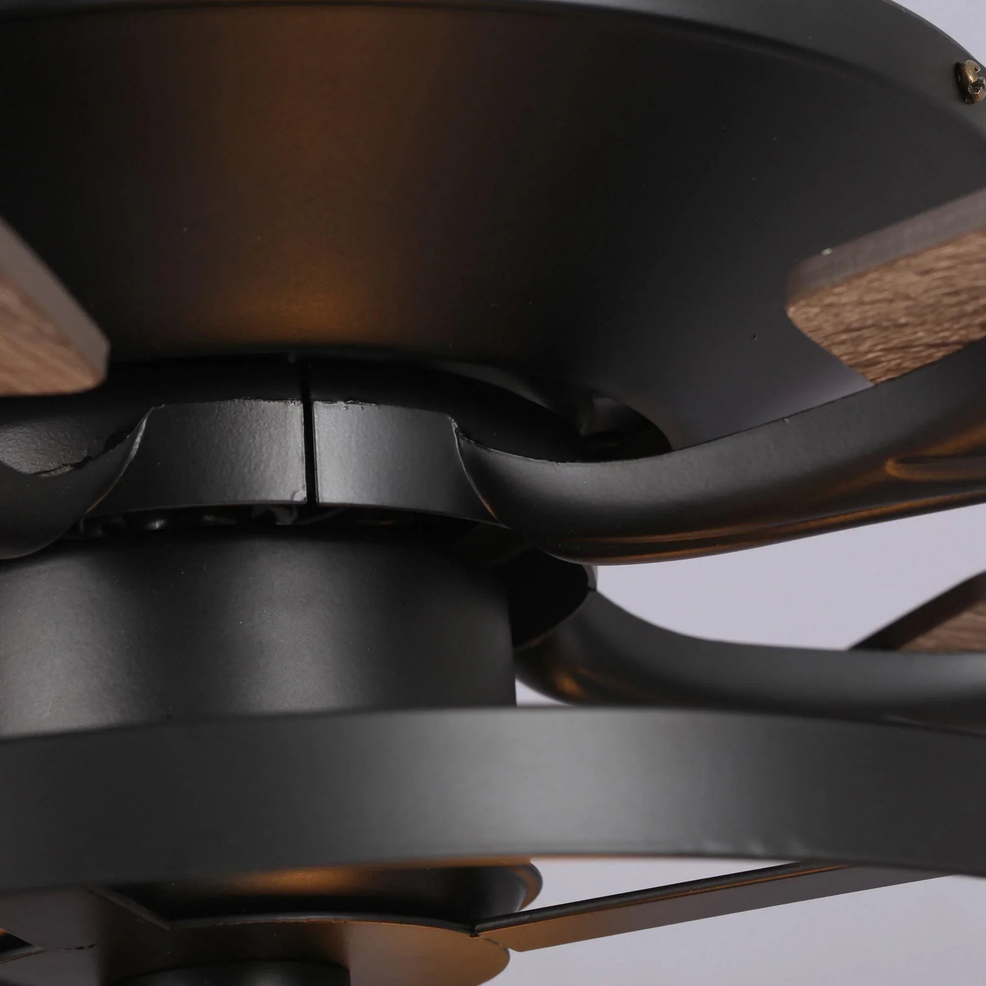 Black ceiling fan motor housing and blade support near the hub