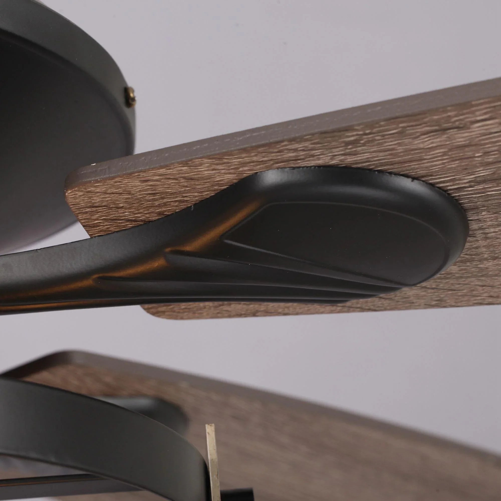 Black ceiling fan blade with dark, wood-grain finish and smooth housing