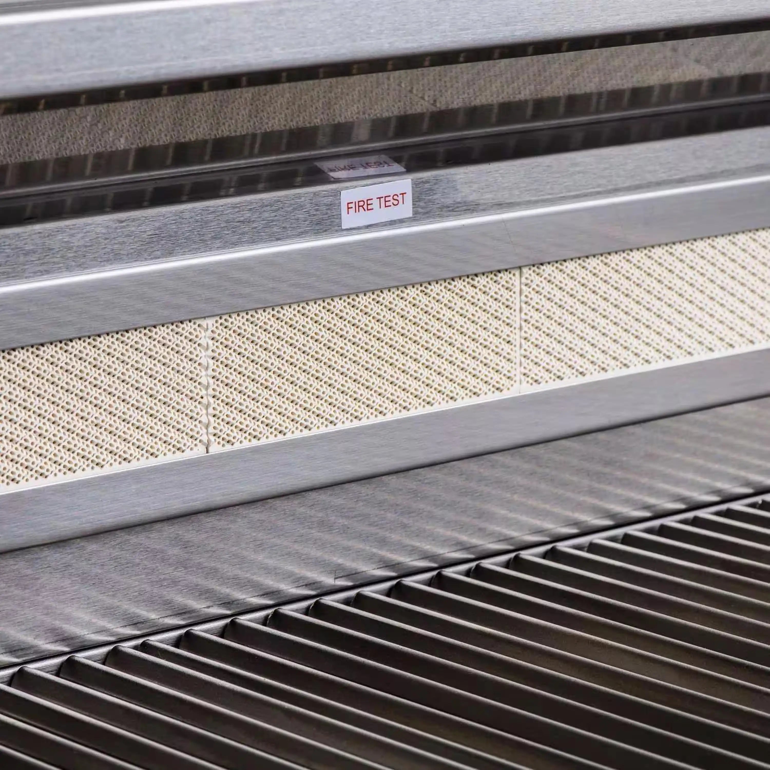 Close-up of grill interior controls area with "FIRE TEST" label