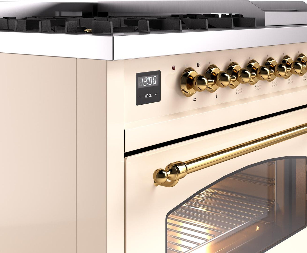Brass control knobs and digital display on white range; oven door with handle