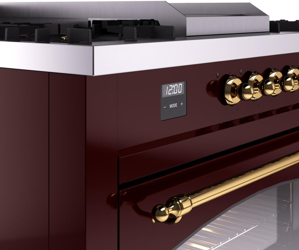 Burgundy dual fuel range control panel with digital display and brass knob row