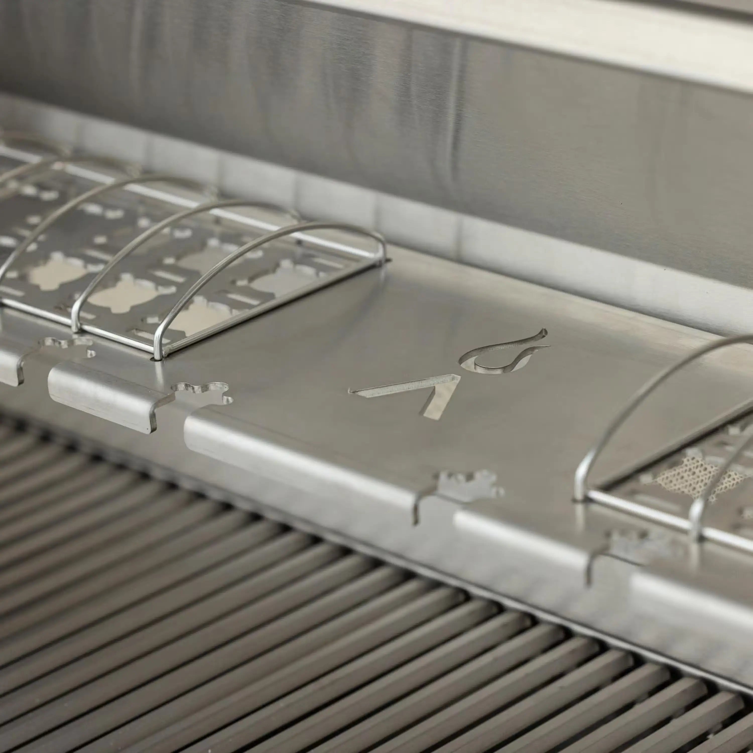 Stainless steel grill cooking surface with removable grates and open lid supports