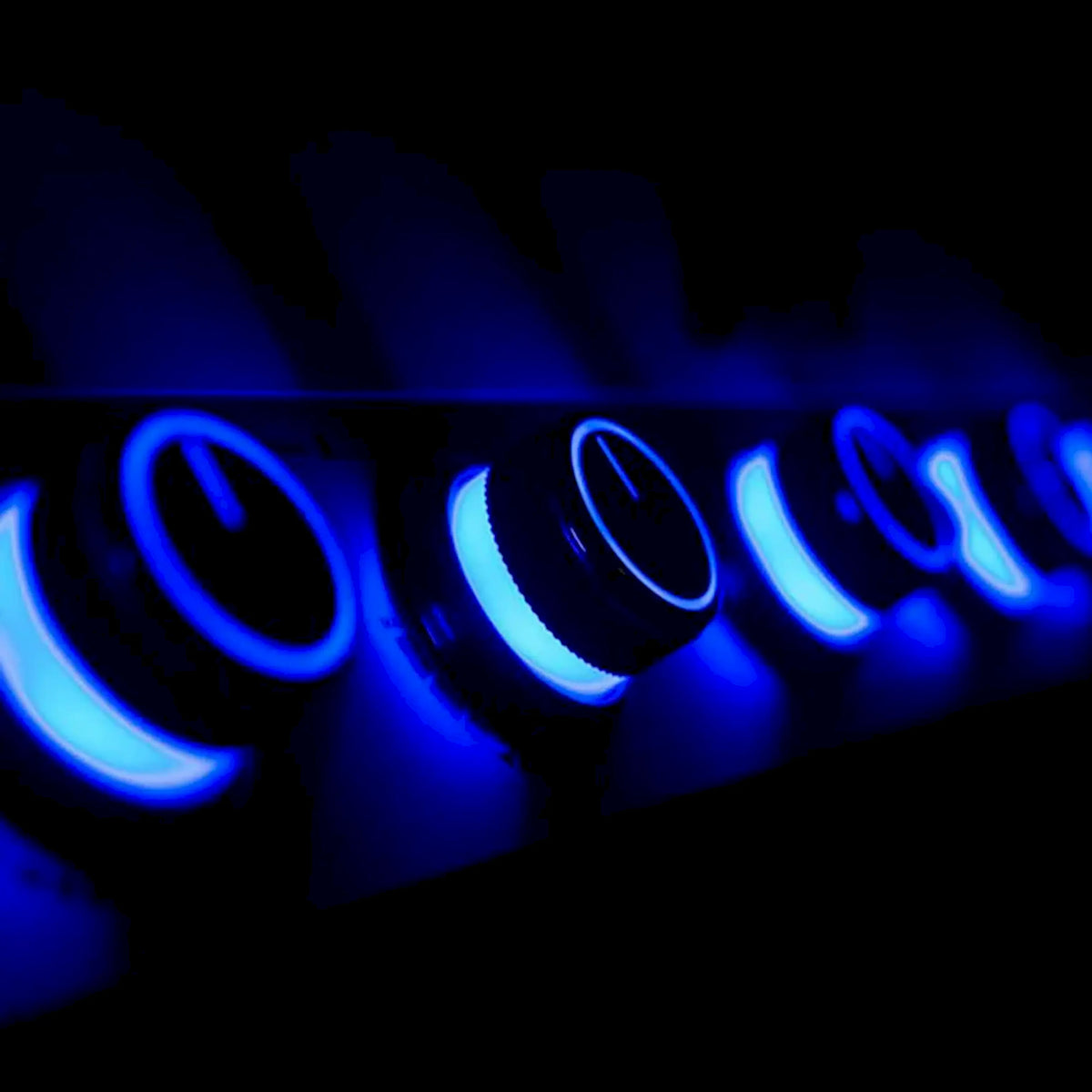 Blue-lit burner flames in an infrared propane gas grill