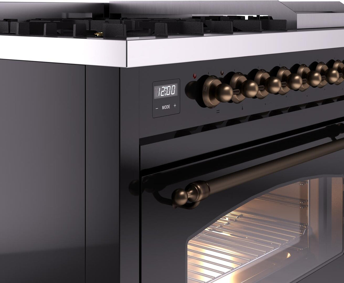 Bronze knob and black control panel on freestanding dual fuel range with oven door below