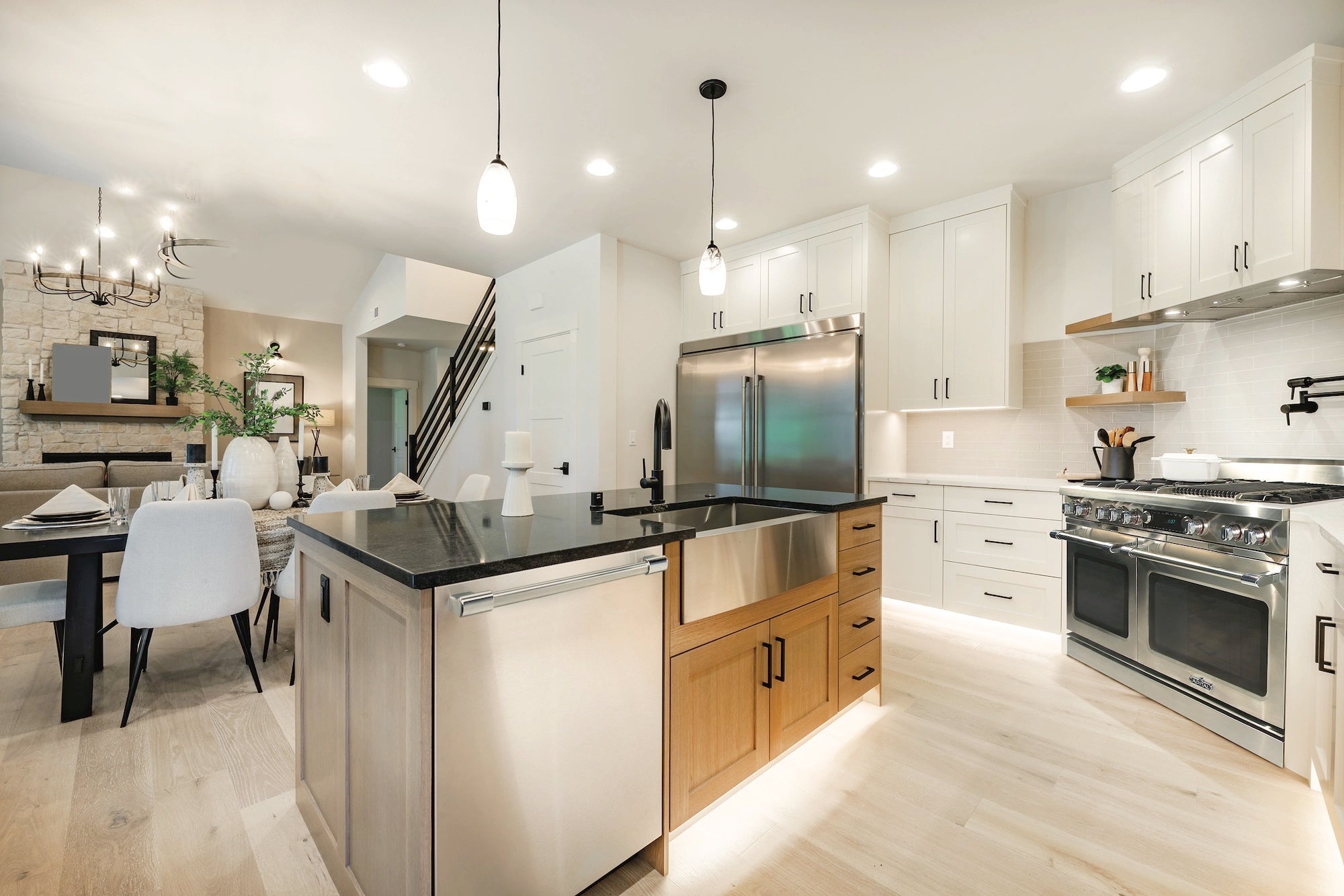 Stainless steel range installed in a modern kitchen with gas cooktop and double ovens