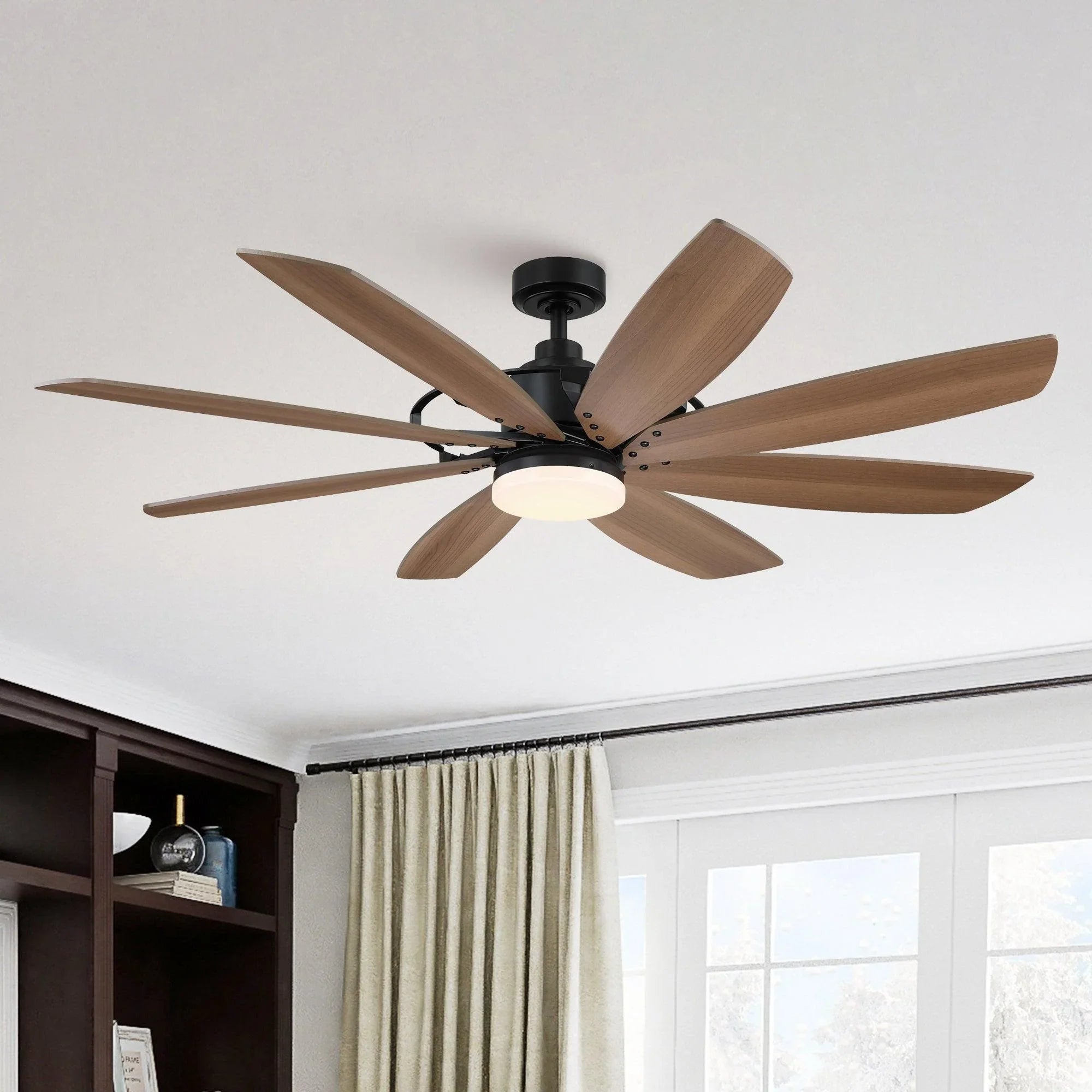 Black ceiling fan motor with wood blades and flush-mount white light globe.