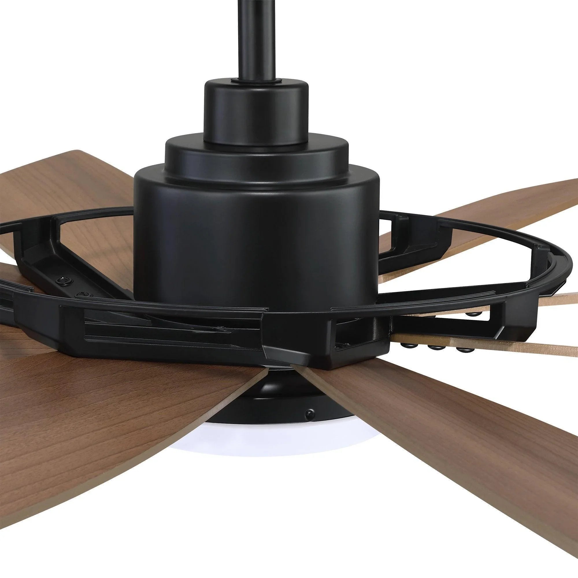 Close-up of black ceiling fan motor housing with wood blades and blade brackets.