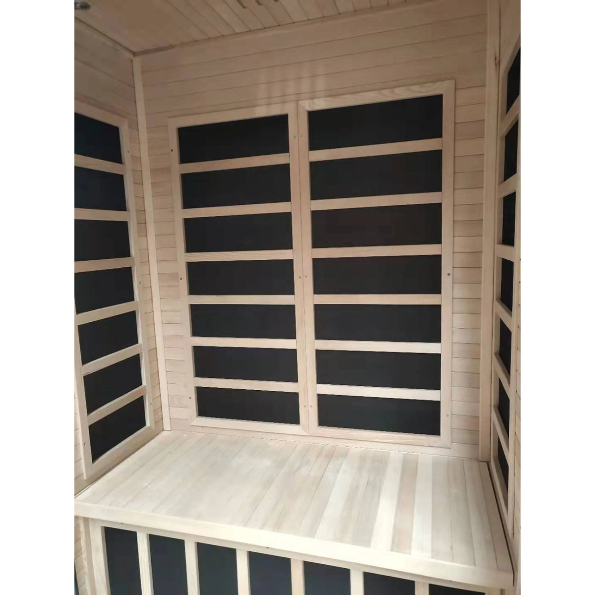 Wood infrared sauna corner with bench seat and dark glass wall panels.
