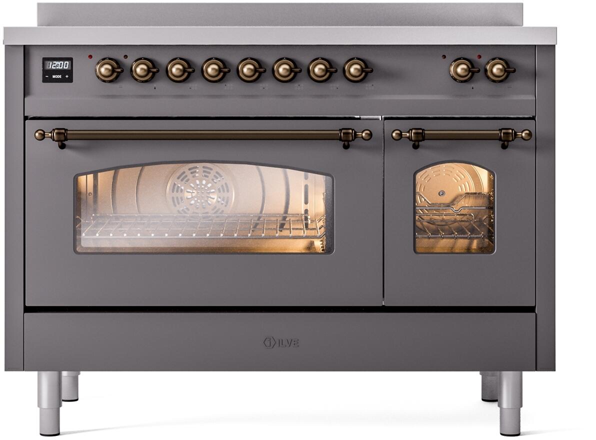 Matte graphite oven door open with illuminated racks and bronze handle trim