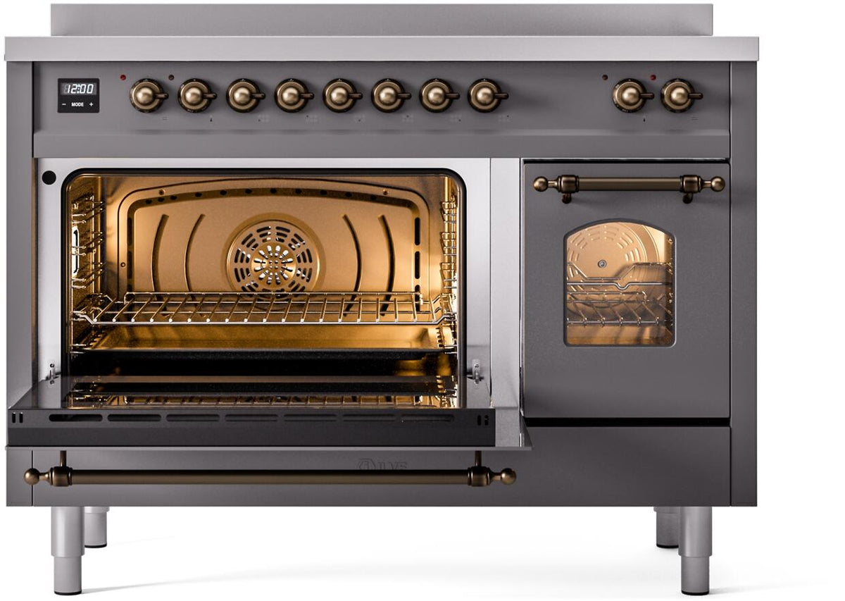 Freestanding range with oven door open, lit baking chamber, and bronze accents