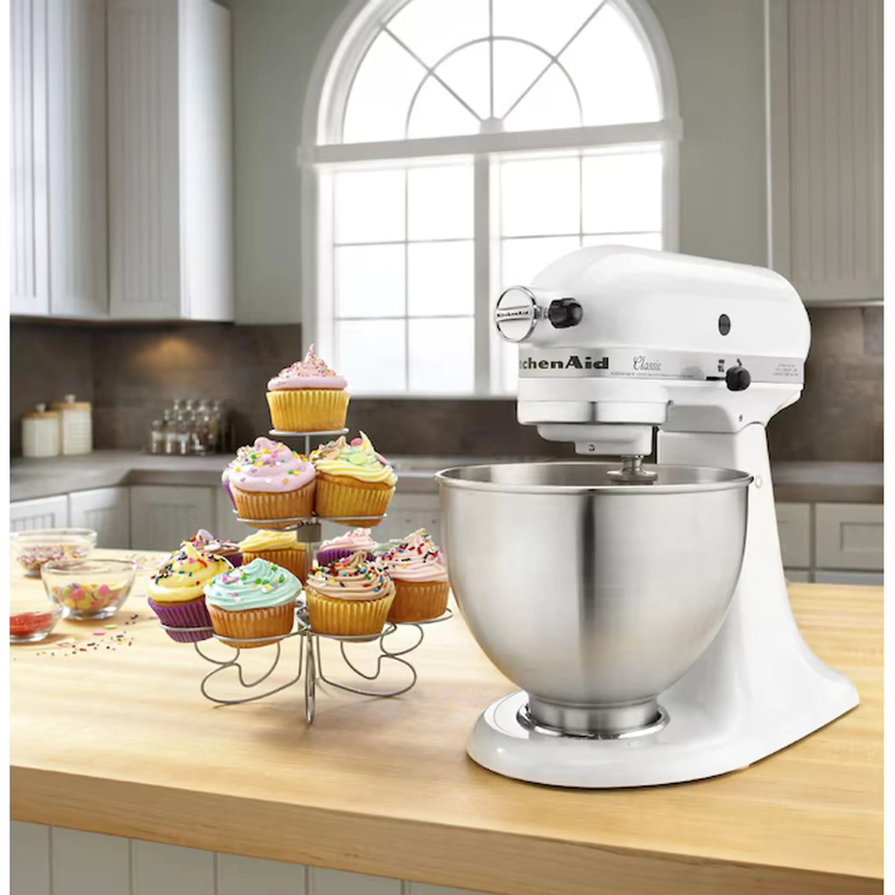 White stand mixer with stainless bowl and tilt-head motor housing on countertop