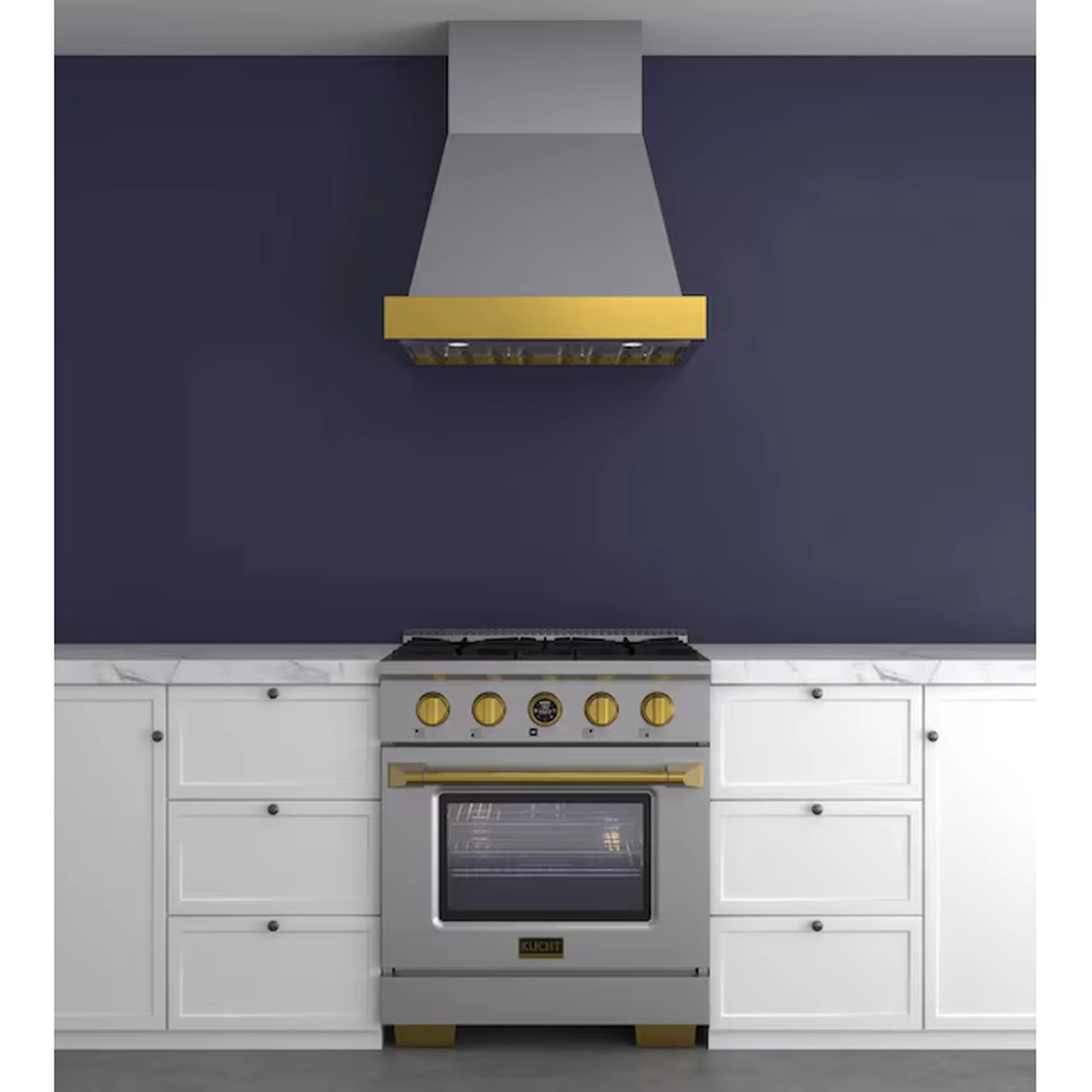 Wall-mounted ducted range hood in dark finish with gold trim above a cooking range