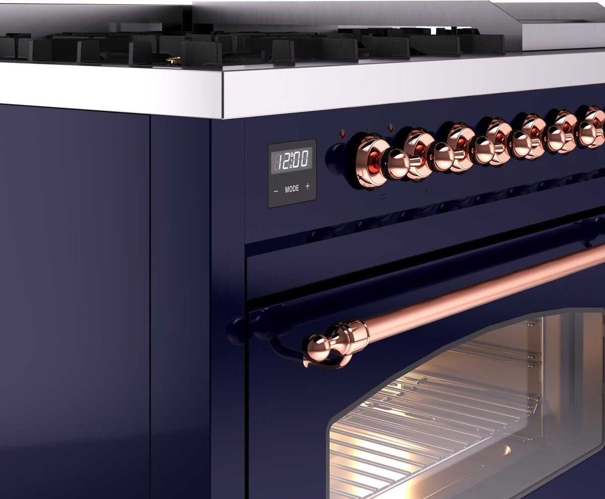 Midnight blue freestanding dual fuel range with copper control knobs and oven door