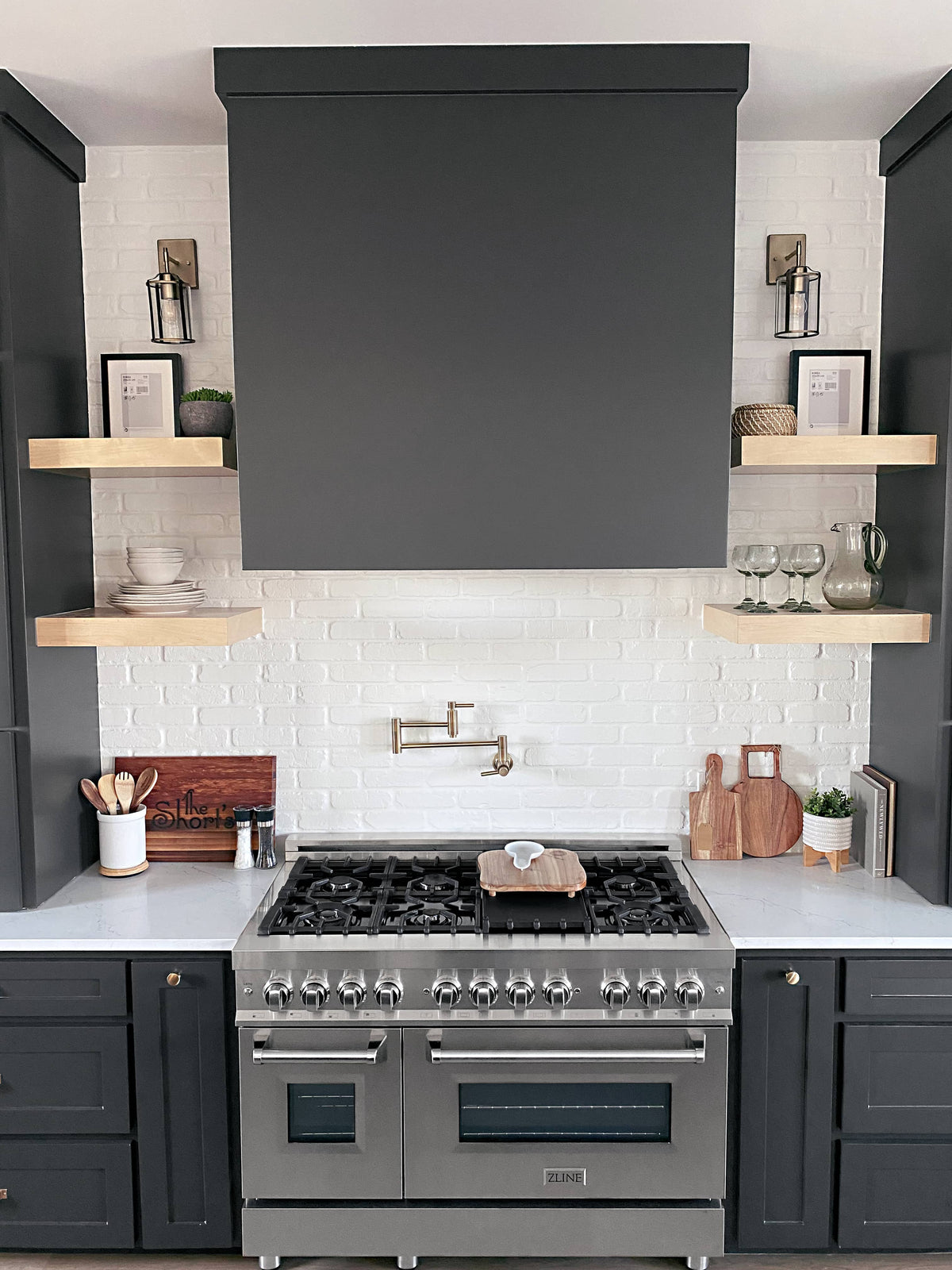 Stainless dual-fuel range with six gas burners in dark kitchen cabinetry