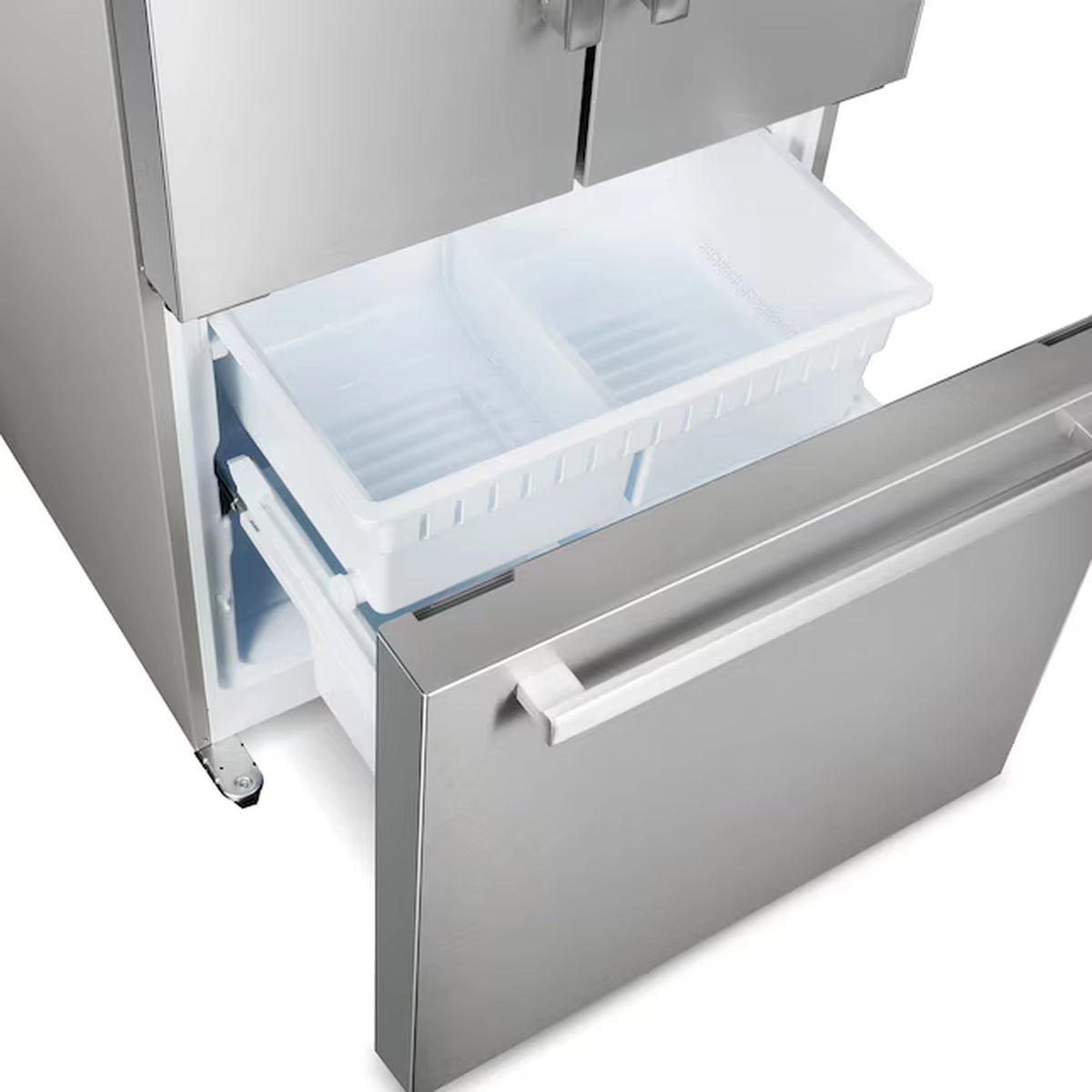 Stainless steel freezer drawer open with white ice bin and ridged interior tray