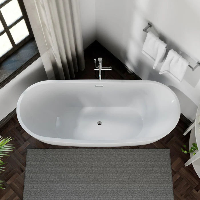 White freestanding soaking tub with silver drain fitting and oval interior