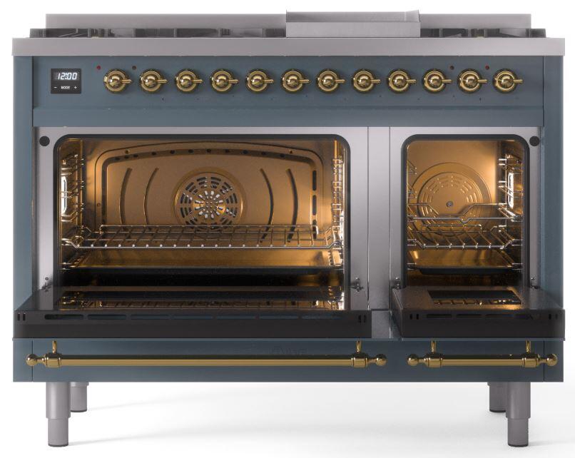 Blue grey double oven range with brass handles and two open oven doors.