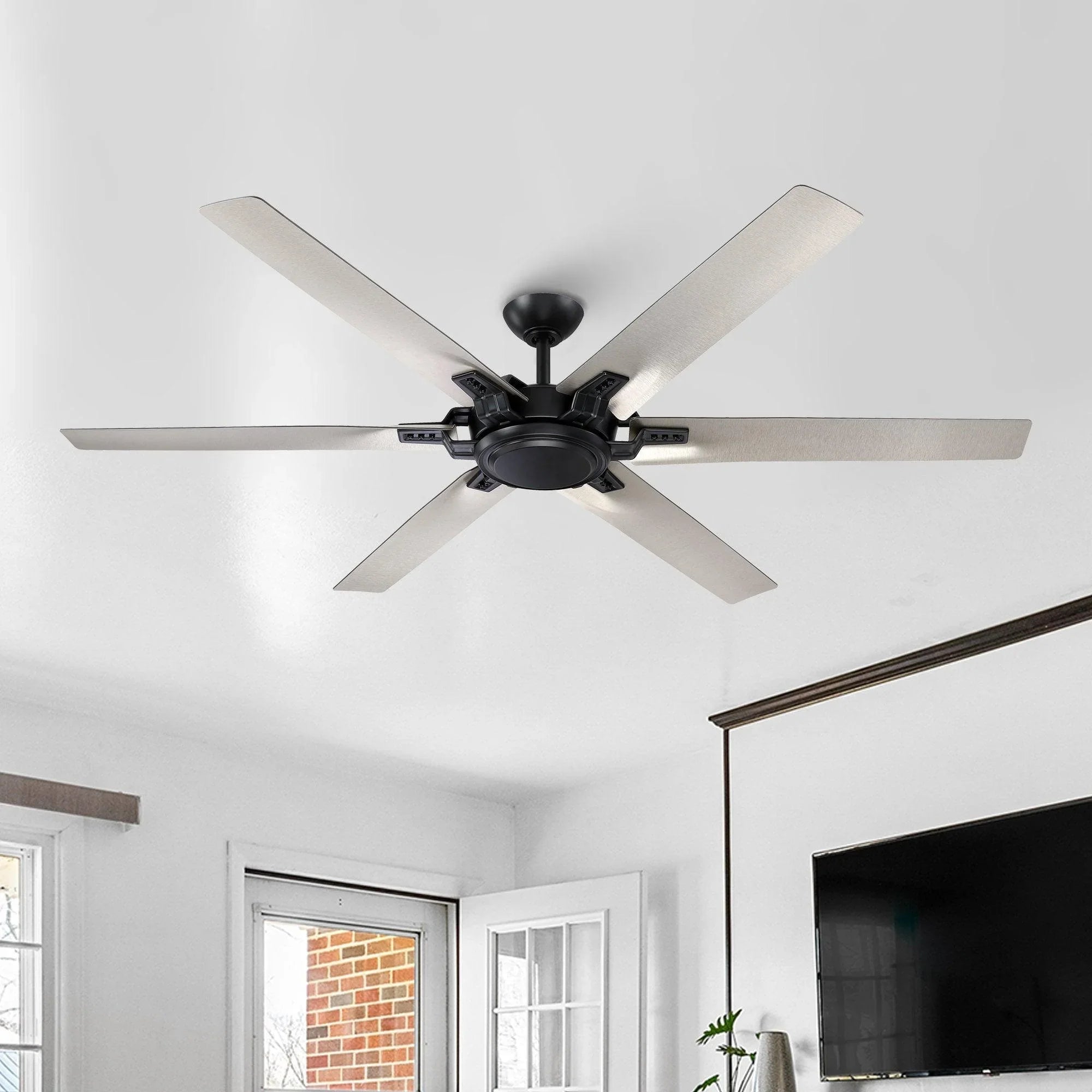 Black ceiling fan with five light wood-toned blades on a ceiling